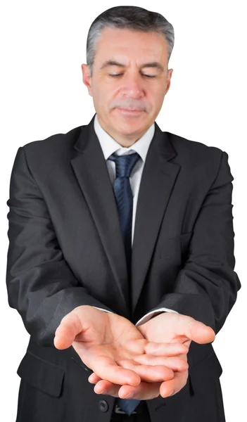 Mature businessman holding his hands out — Stock Photo, Image