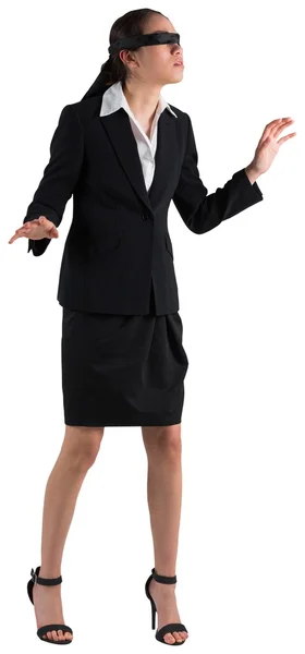 Blindfolded businesswoman with hands out — Stock Photo, Image