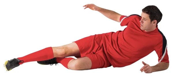 Jogador de futebol em pontapés vermelhos — Fotografia de Stock