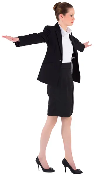 Businesswoman performing a balancing act Stock Image