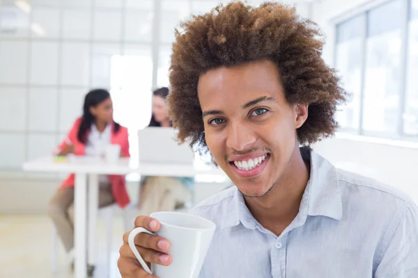 Empresario con compañeros de trabajo detrás — Foto de Stock