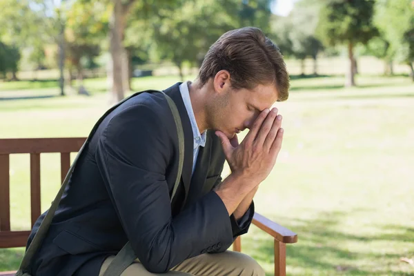 Worried businessman on park bench — Stock Photo, Image