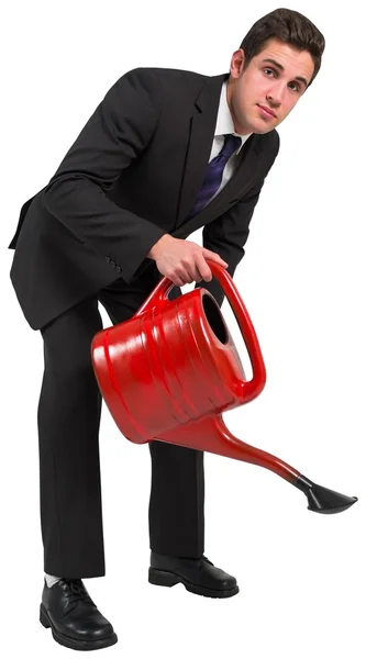 Businessman watering with can — Stock Photo, Image