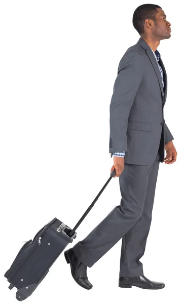 Young businessman pulling his suitcase — Stock Photo, Image