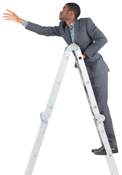 Businessman climbing up ladder — Stock Photo, Image