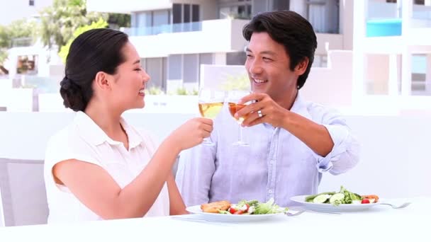 Asian couple having wine with meal — Stock Video