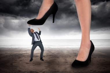 Businesswoman stepping on tiny businessman clipart