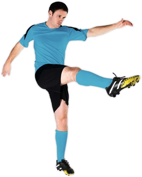 Jogador de futebol em azul chutando — Fotografia de Stock