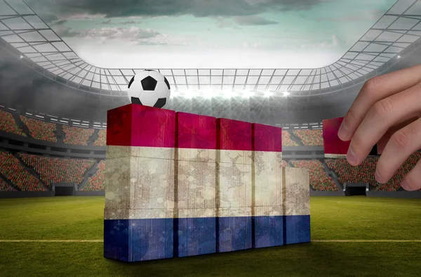 Hand building wall of netherlands flag — Stock Photo, Image