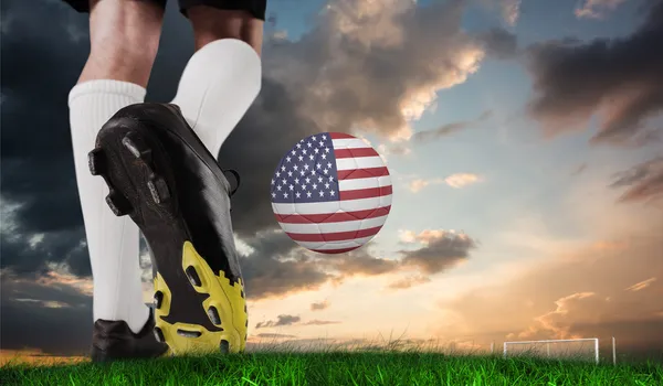 Football boots against green grass — Stock Photo, Image