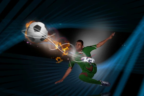 Football player in green kicking — Stock Photo, Image