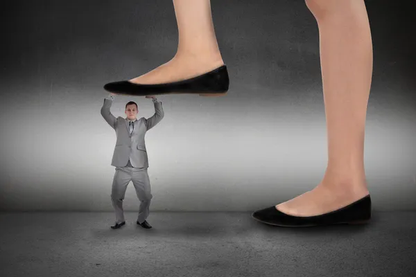 Businesswoman stepping on businessman — Stock Photo, Image