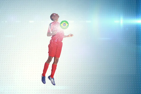 Football player in red jumping — Stock Photo, Image