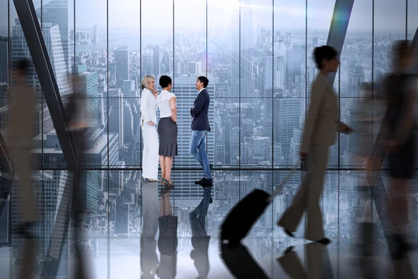 Business colleagues talking against large window — Stock Photo, Image