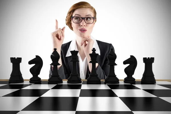 Thinking businesswoman with chessboard — Stock Photo, Image