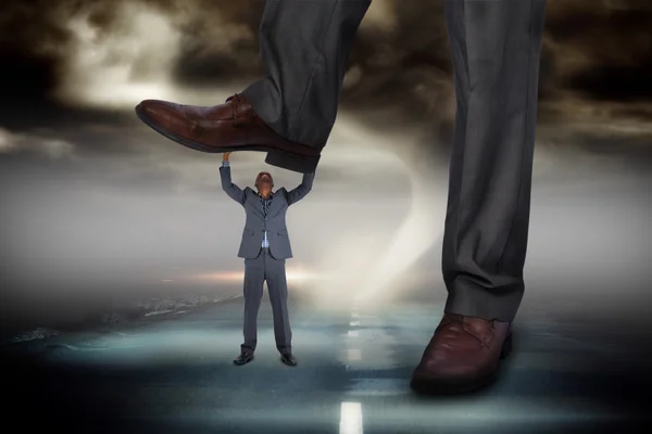 Businessman stepping on tiny businessman — Stock Photo, Image