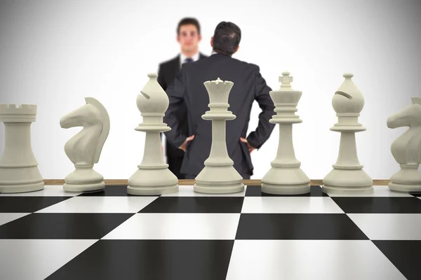 Businessmen and chess pieces — Stock Photo, Image