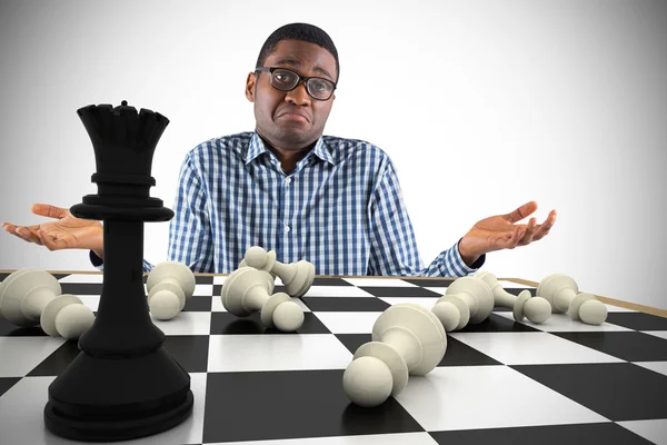 Businessman shrugging shoulders with chessboard — Stock Photo, Image