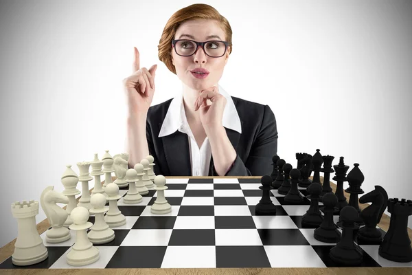 Thinking businesswoman with chessboard — Stock Photo, Image