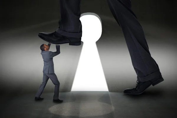 Businessman stepping on tiny businessman — Stock Photo, Image