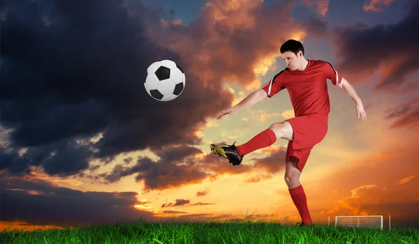 Piłkarz w czerwony dziurkacz — Zdjęcie stockowe