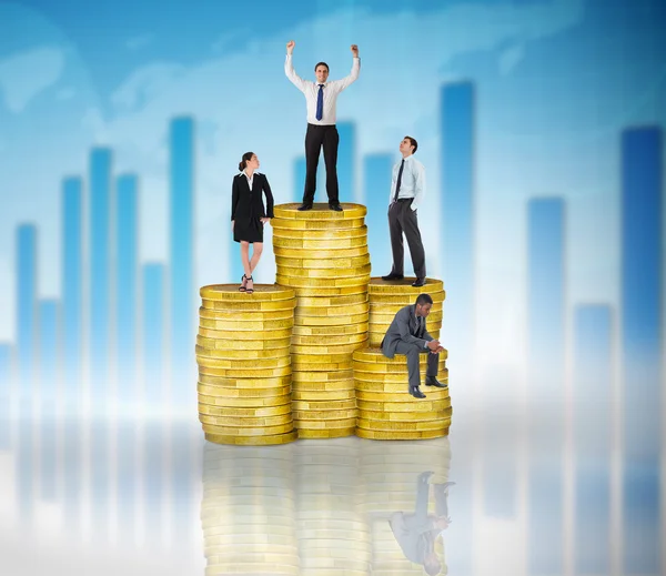 Composite image of business people on pile of coins — Stock Photo, Image