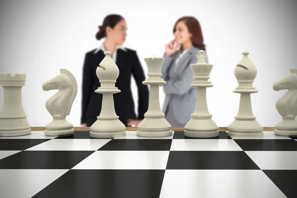 Businesswomen and chess pieces — Stock Photo, Image