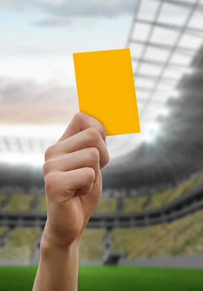 Hand holding up yellow card — Stock Photo, Image