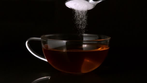 Teaspoon pouring sugar into cup — Stock Video