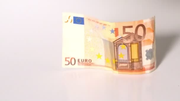 Billets en euros tombant sur la surface blanche — Video