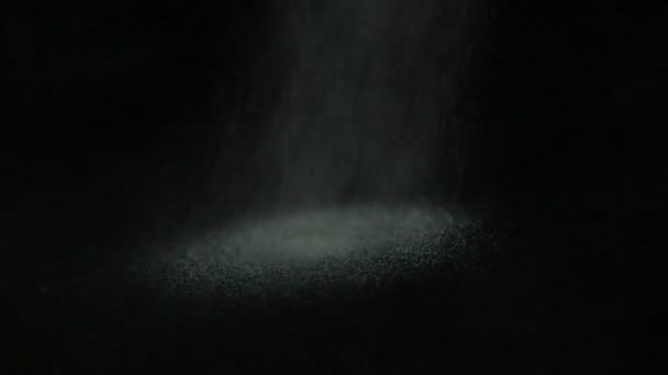 Sand pouring on black surface — Stock Video