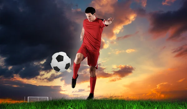 Football player in red kicking — Stock Photo, Image