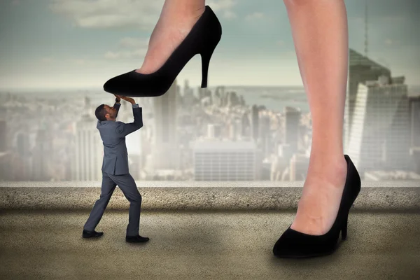 Businesswoman stepping on tiny businessman — Stock Photo, Image