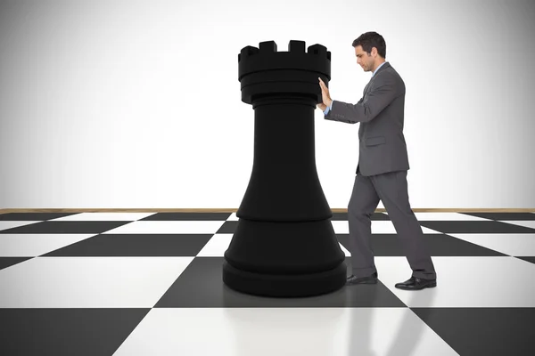 Businessman pushing chess piece — Stock Photo, Image