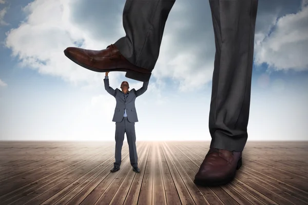 Businessman stepping on tiny businessman — Stock Photo, Image