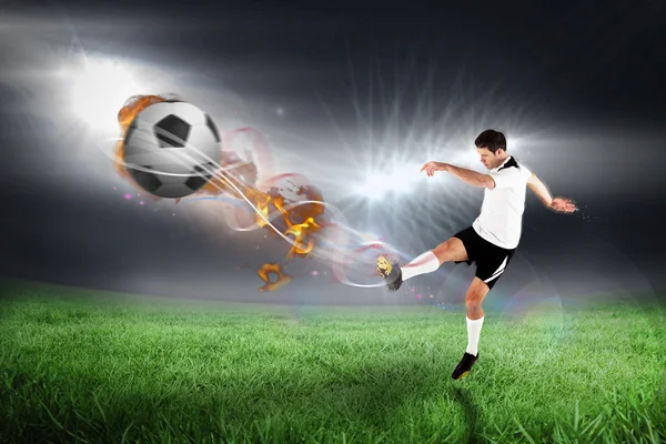 Football player in white kicking — Stock Photo, Image