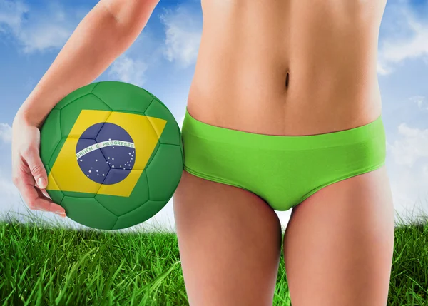 Girl in bikini holding brazil footb — Stock Photo, Image