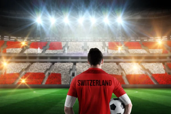 Samengestelde afbeelding van Zwitserse voetbal speler die bal — Stockfoto