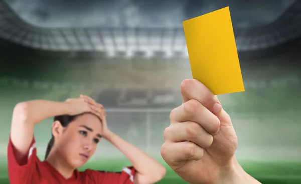 Hand holding up yellow card to fan — Stock Photo, Image