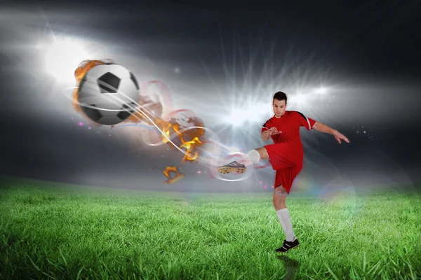 Football player in red kicking — Stock Photo, Image