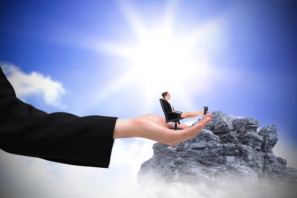 Businesswoman on chair with feet up in hand — Stock Photo, Image