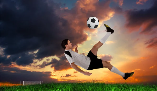 Football player in white kicking — Stock Photo, Image