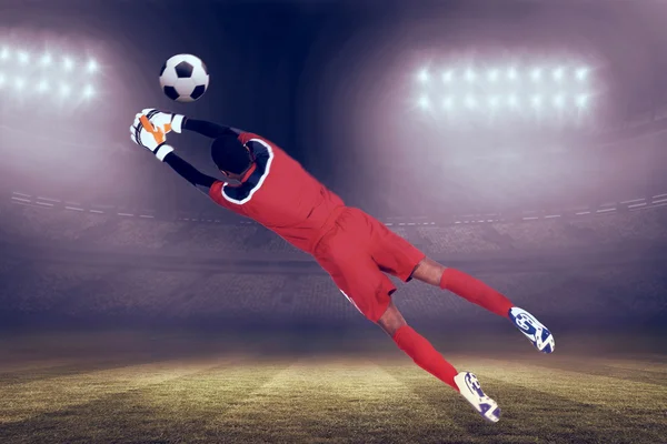 Goalkeeper in red making save — Stock Photo, Image