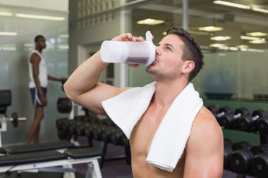 Bodybuilder drinking protein drink clipart
