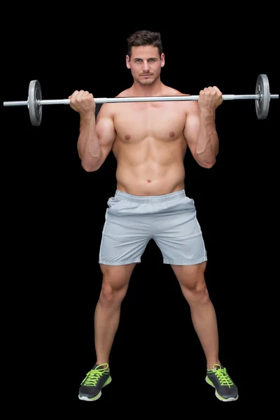 Serious crossfitter lifting up barbell — Stock Photo, Image