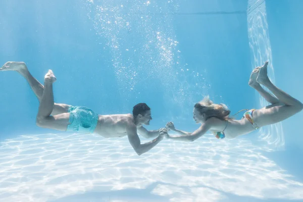 Couple holding hands underwater — Stock Photo, Image