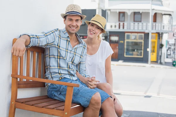 Couple assis sur banc souriant — Photo