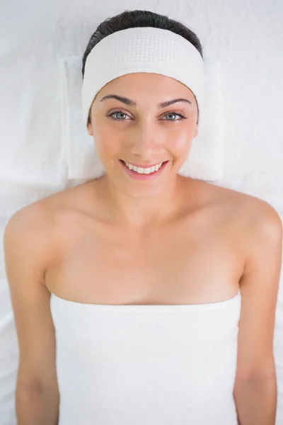 Brunette lying on massage table — Stock Photo, Image