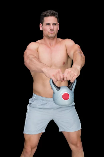 Focused bodybuilder swinging up kettlebell — Stock Photo, Image