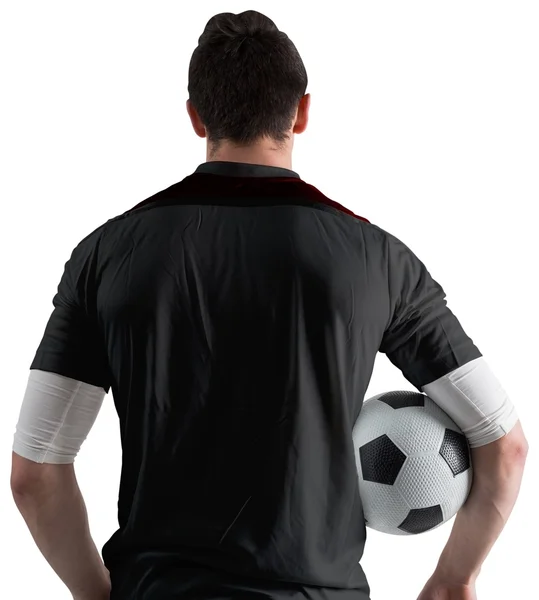 Football player in black holding ball — Stock Photo, Image